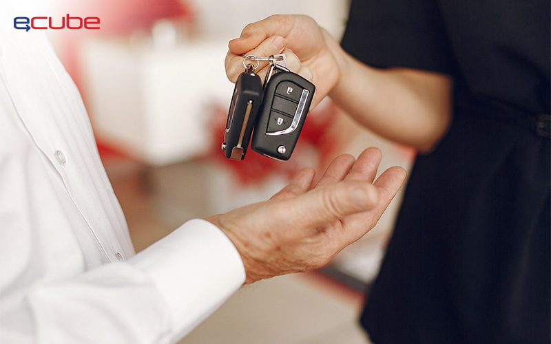 Rental car keys being handed over to customer