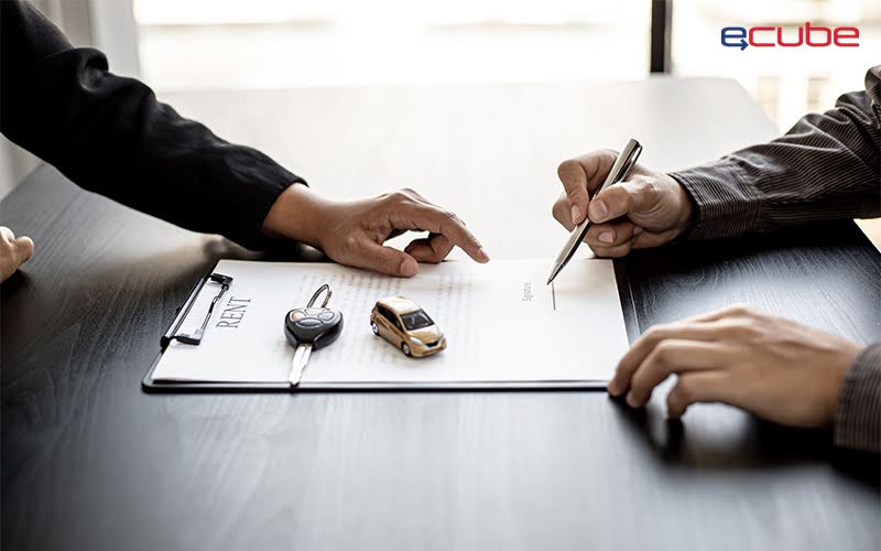 Signing ECube car rental agreement with key and form.