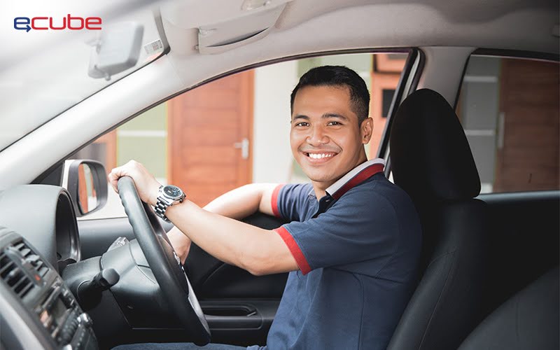 Smiling PHV driver sitting behind the wheel