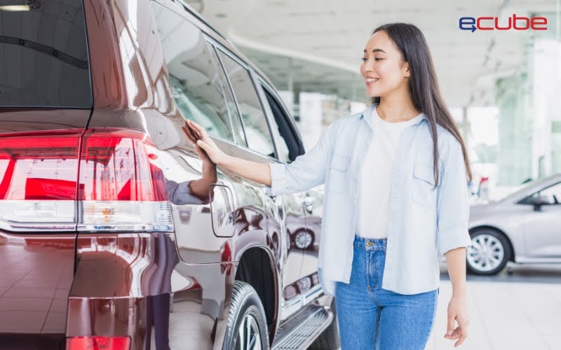 Woman viewing a car in a dealership