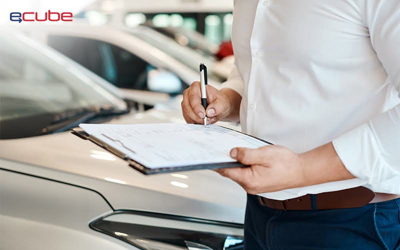 man signing a vehicle leasing