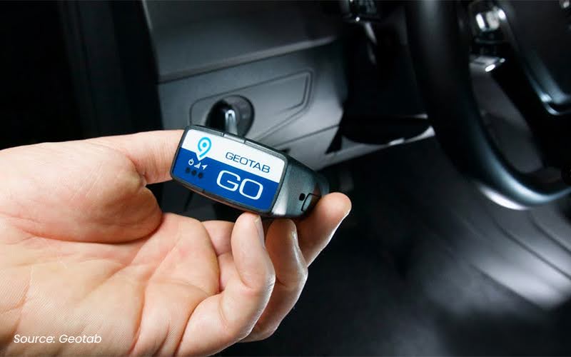 person holding a geotab telematics system